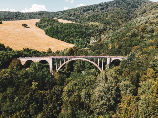 Aerial view of the historical stone railway bridge in Slovakia. High, fully preserved stone arch railway bridge.