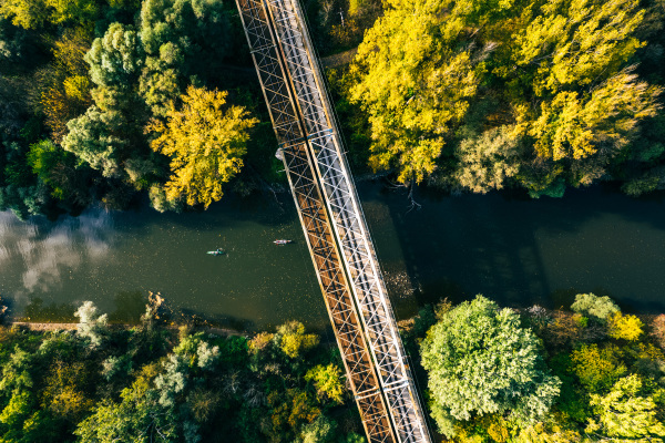 Aerial view of big metal railway bridge in the Slovakia, in the middle of summer forest, no train.