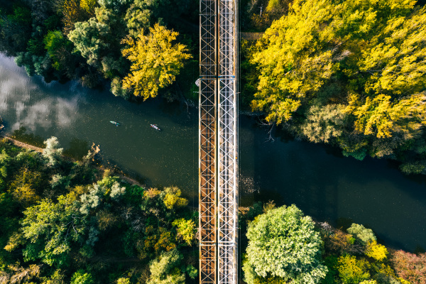 Aerial view of big metal railway bridge in the Slovakia, in the middle of summer forest, no train.