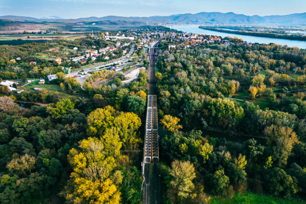 Aerial view of big metal railway bridge in the Slovakia, in the middle of summer forest, no train.