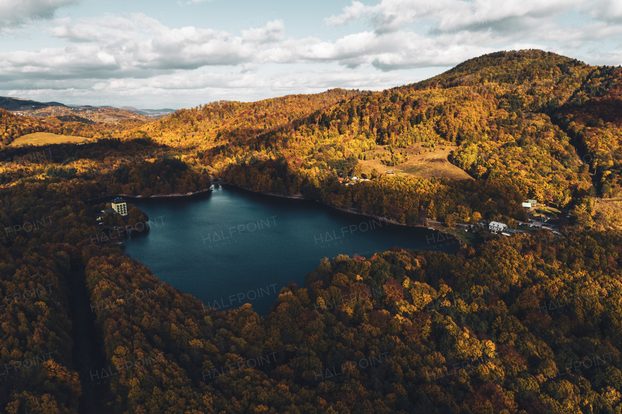 Top view of lake in the middle of beautiful autumn forest in Slovakia. Europe traveling concept.