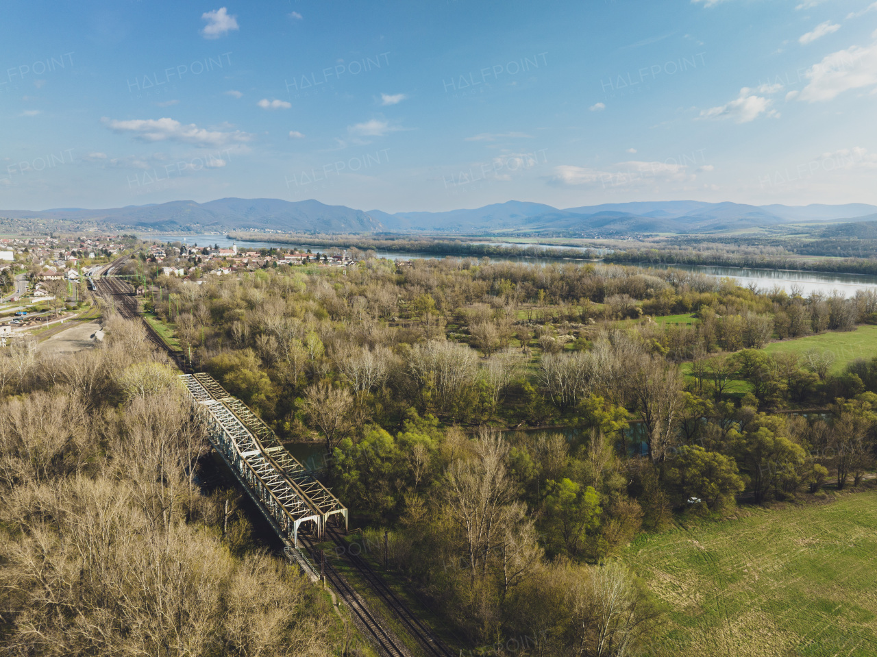 Aerial view of big metal railway bridge in the Slovakia, in the middle of summer forest, no train.