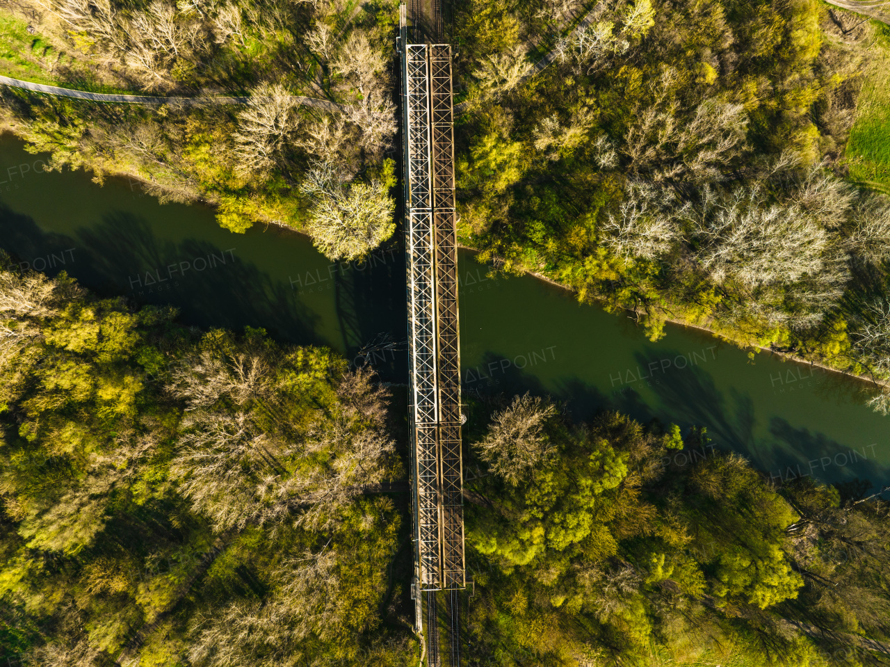 Aerial view of big metal railway bridge in the Slovakia, in the middle of summer forest, no train.