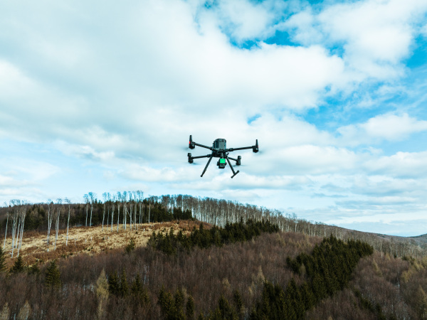 Aerial view of a drone moderning over forest, monitoring and analyzing in the forestry management. Dron mapping forest after natural disaster assessing damage.