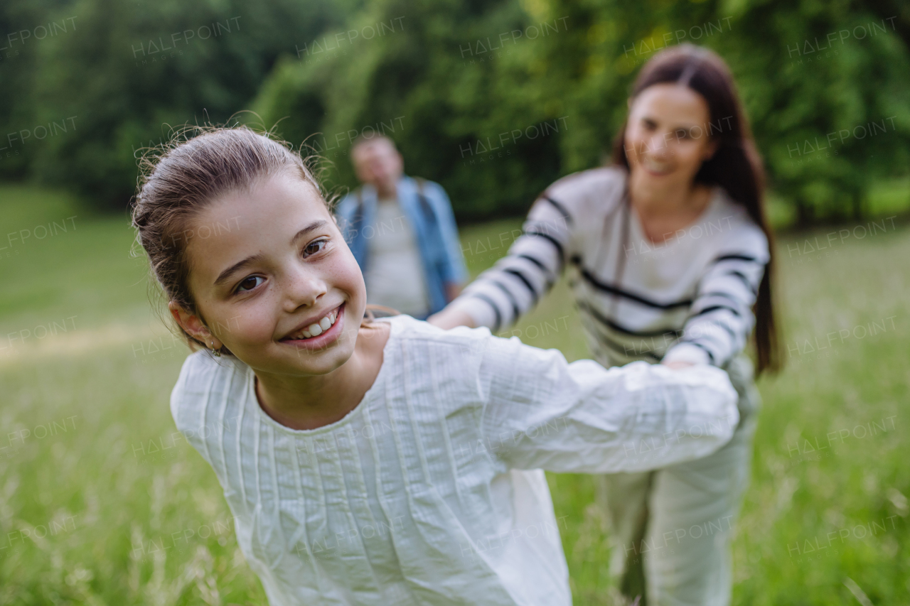 Beautiful mother with daughter, playing at meadow, running and having fun. Concept of Mother's Day and maternal love.