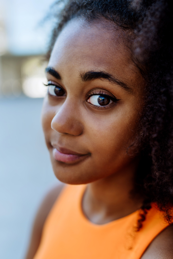 Portrait of young multiracial girl outdoor in a city.