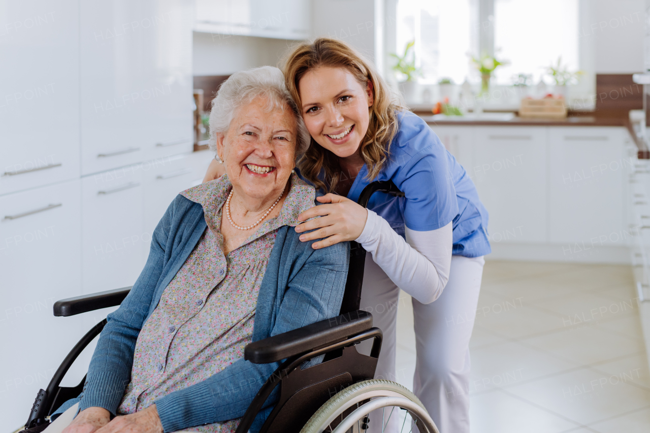 Portrait of nurse and her senior client on a wheelchair.