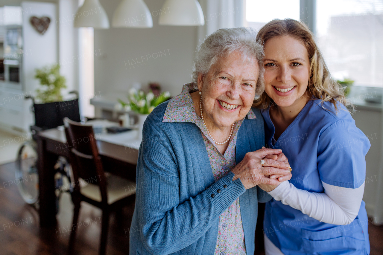 Nurse hugging her senior woman client.