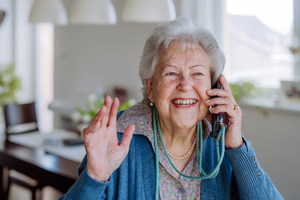 Portrait of senior woman calling with a smartphone.