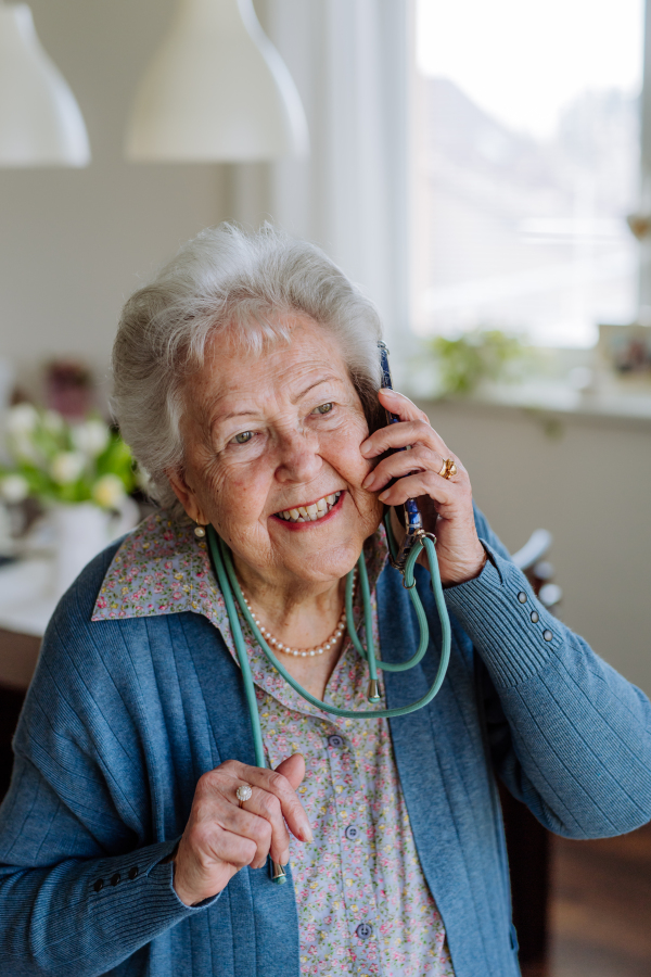 Portrait of senior woman calling with a smartphone.