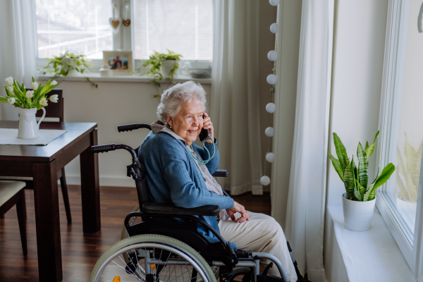 Portrait of senior woman on wheelchair calling.