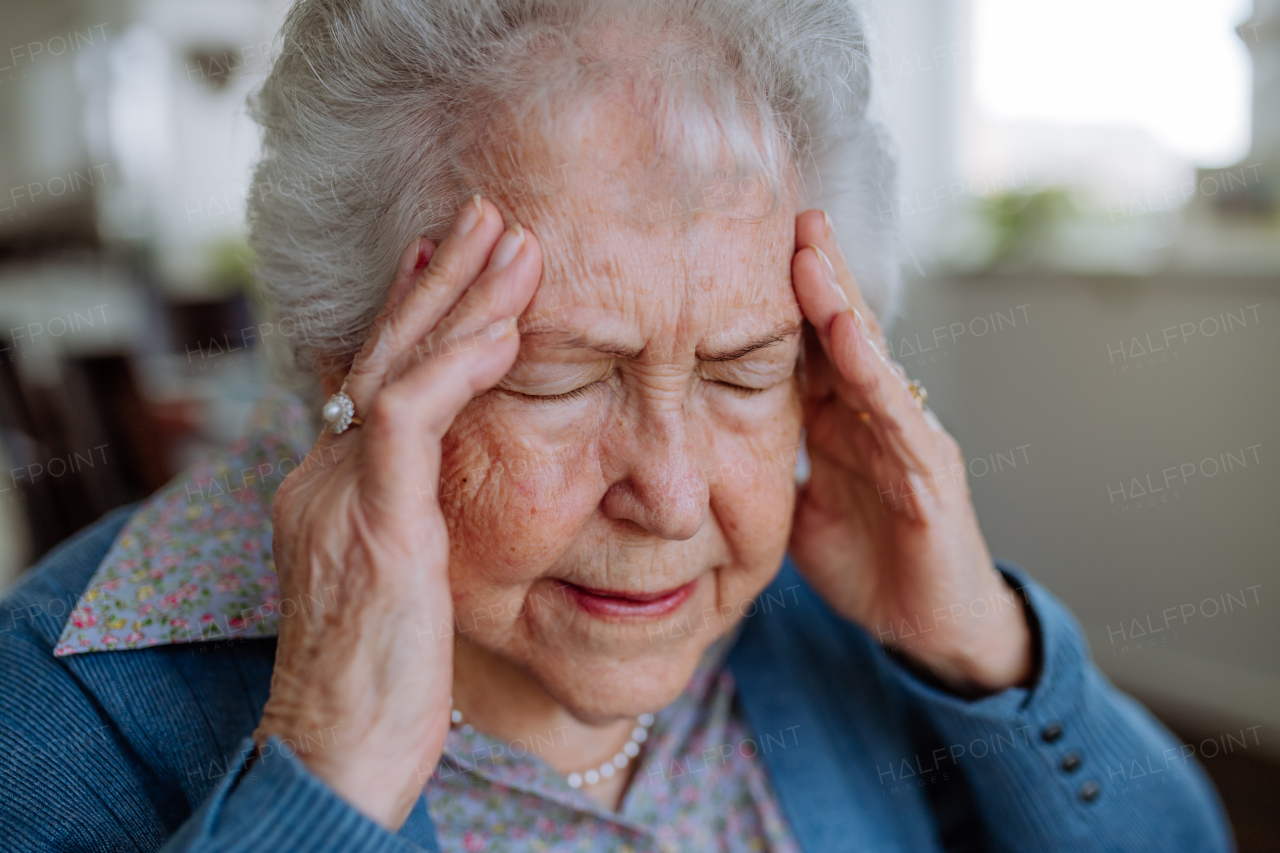 Portrait of elderly senior woman with headache.