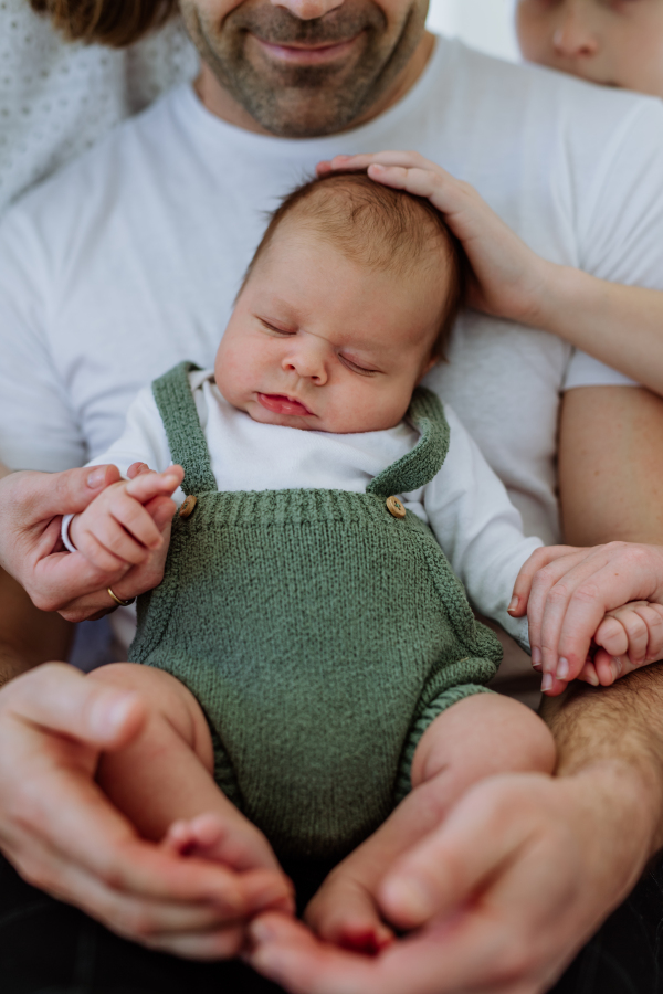 Close-up of father holding his little new born baby.