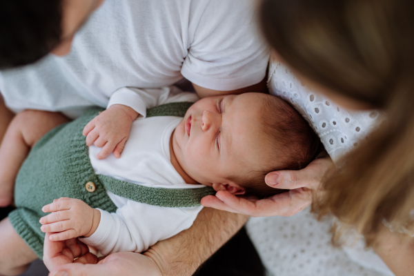 Happy parents cuddling with their newborn son.