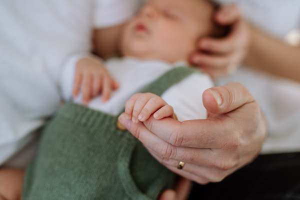 Close-up of father holding his little new born baby.