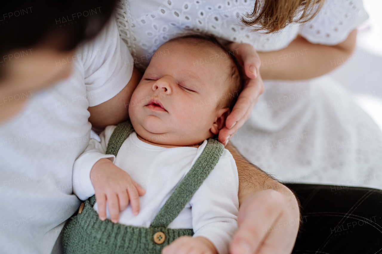 Close up of mother and father holding their baby.