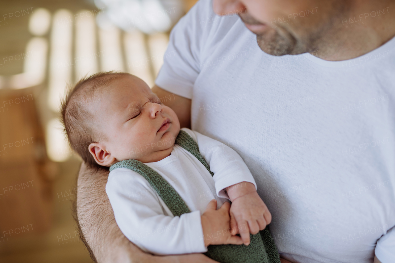 Close-up of father holding his little new born baby.