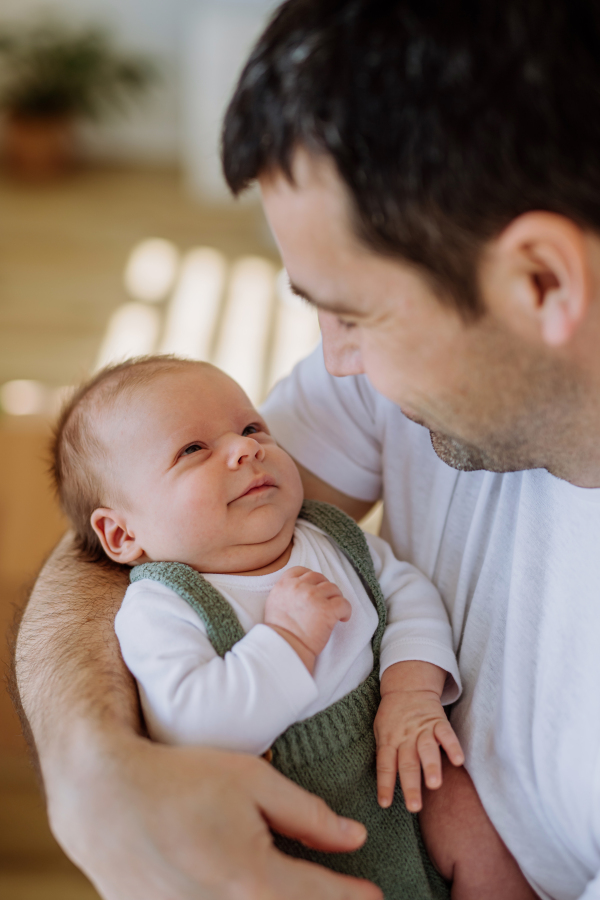 Close-up of father holding his little new born baby.