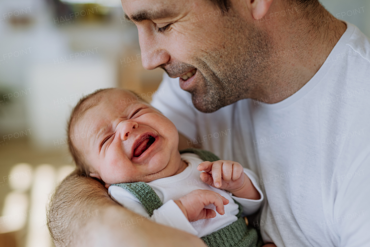 Close-up of father holding his little new born baby.