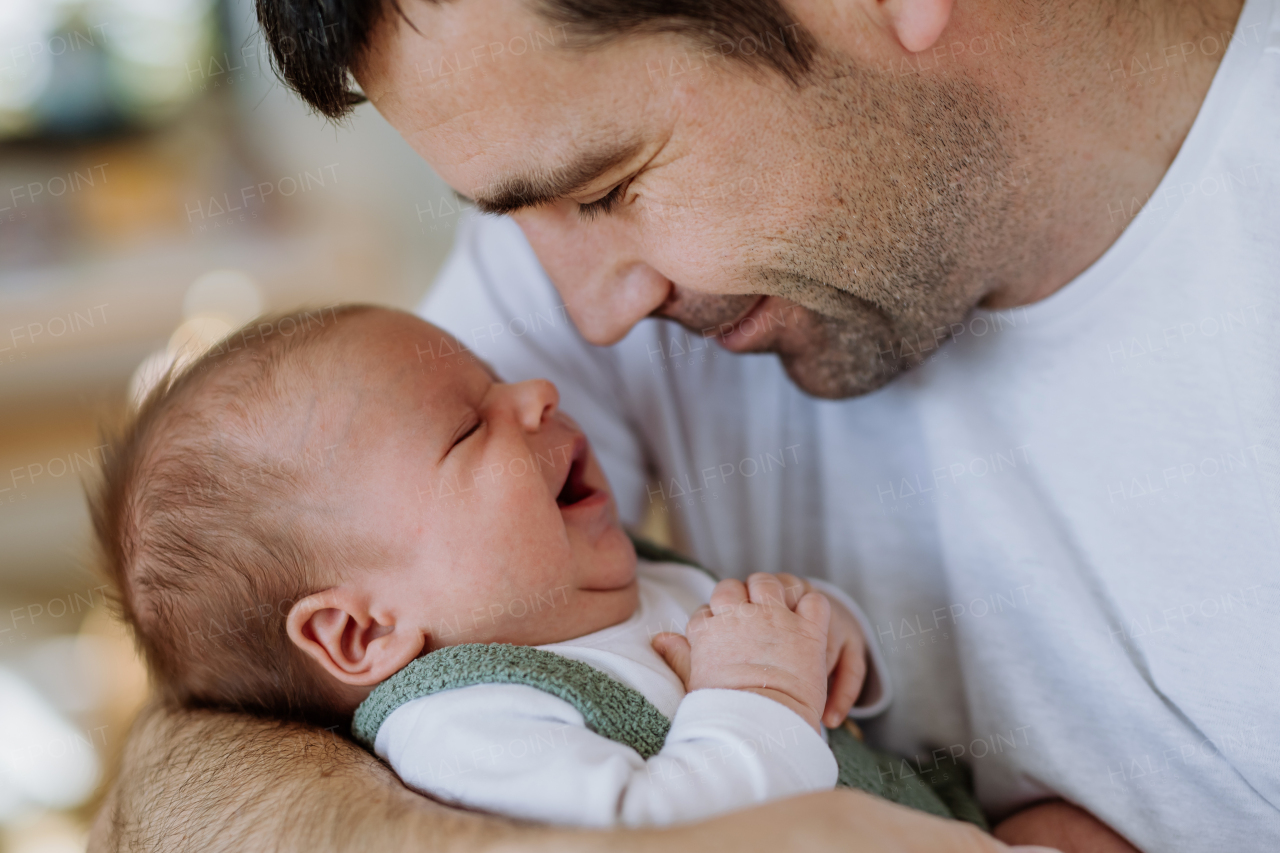 Close-up of father holding his little new born baby.