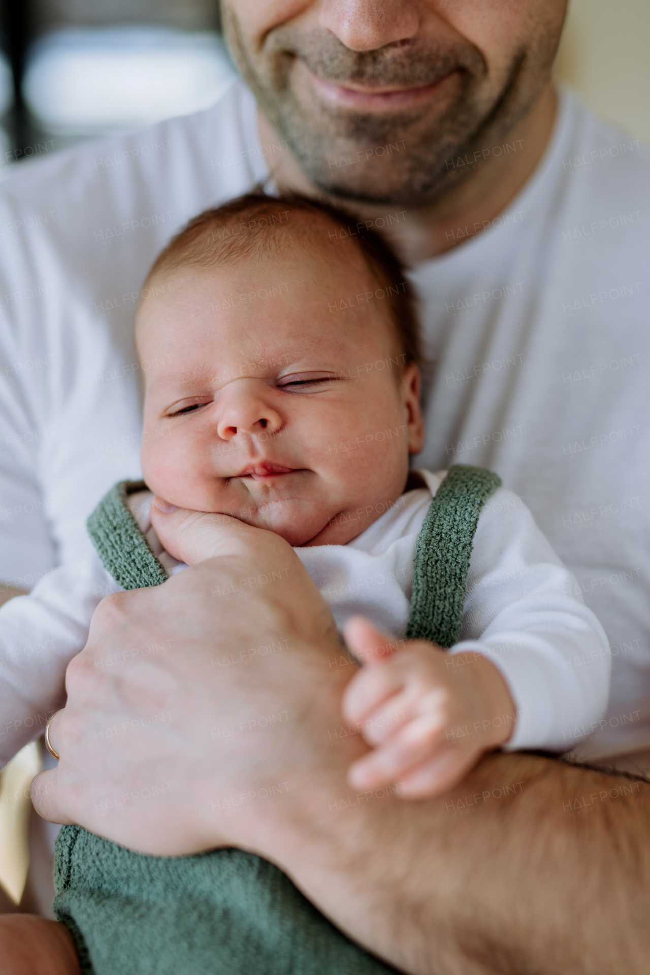 Close-up of father holding his little new born baby.