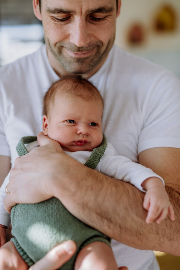 Close-up of father holding his little new born baby.