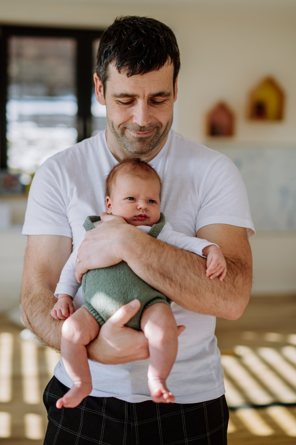 Close-up of father holding his little new born baby.