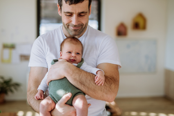 Close-up of father holding his little new born baby.