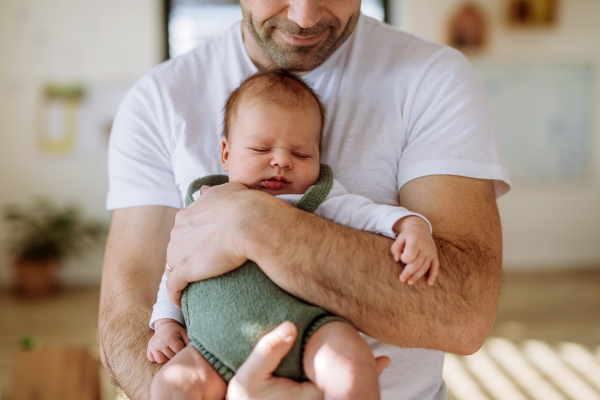 Close-up of father holding his little new born baby.