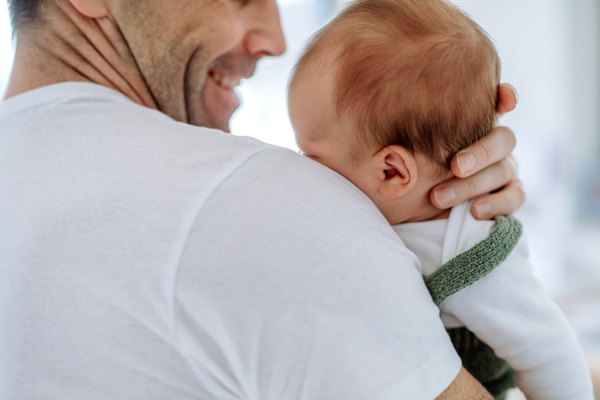 Close-up of father holding his little new born baby.