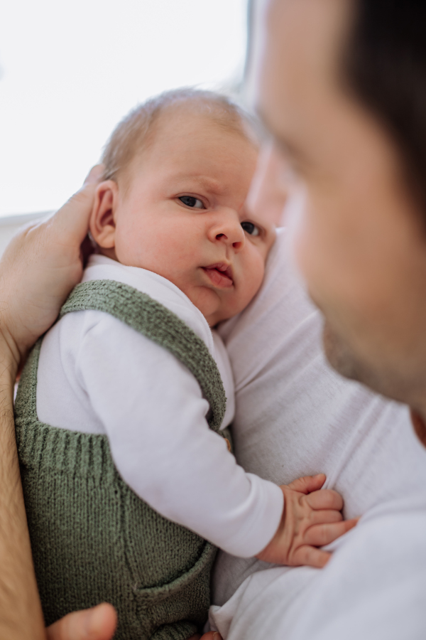 Close-up of father holding his little new born baby.