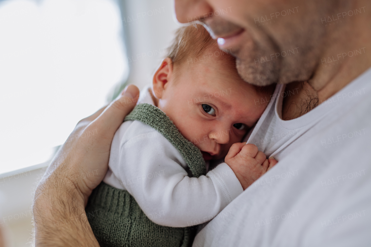 Close-up of father holding his little new born baby.