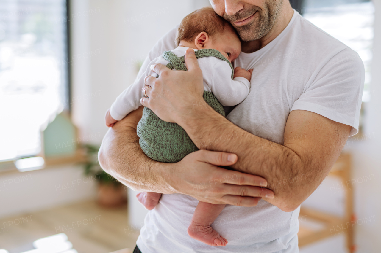 Close-up of father holding his little new born baby.