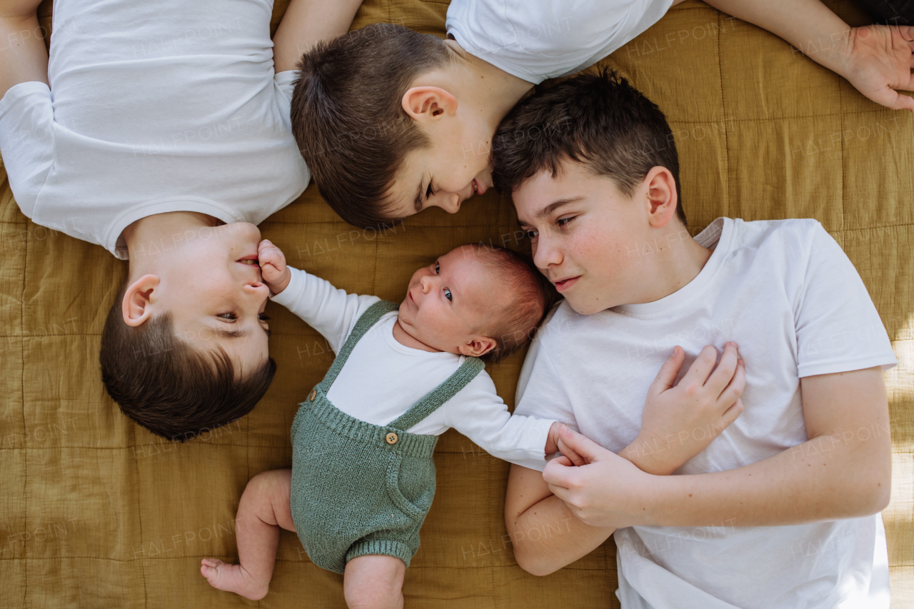 Three big brothers with their newborn brother.