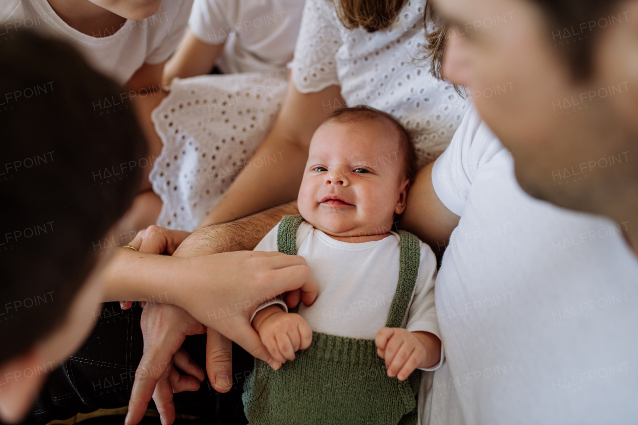 Big family with four sons enjoying their newborn baby.