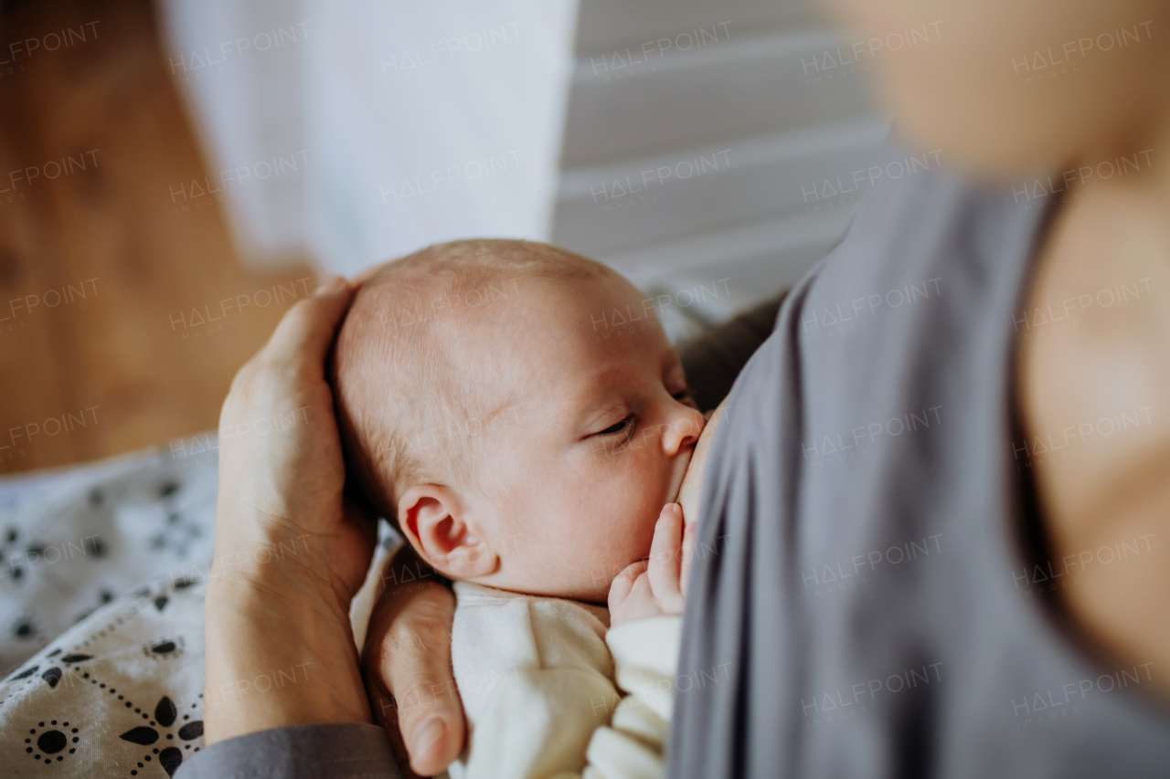 Close-up of mother brestfeeding her little newborn son.