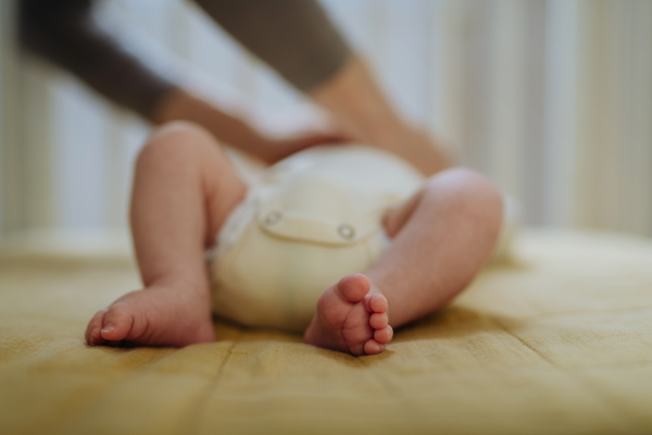 Close up of babys feet lying in cradle.