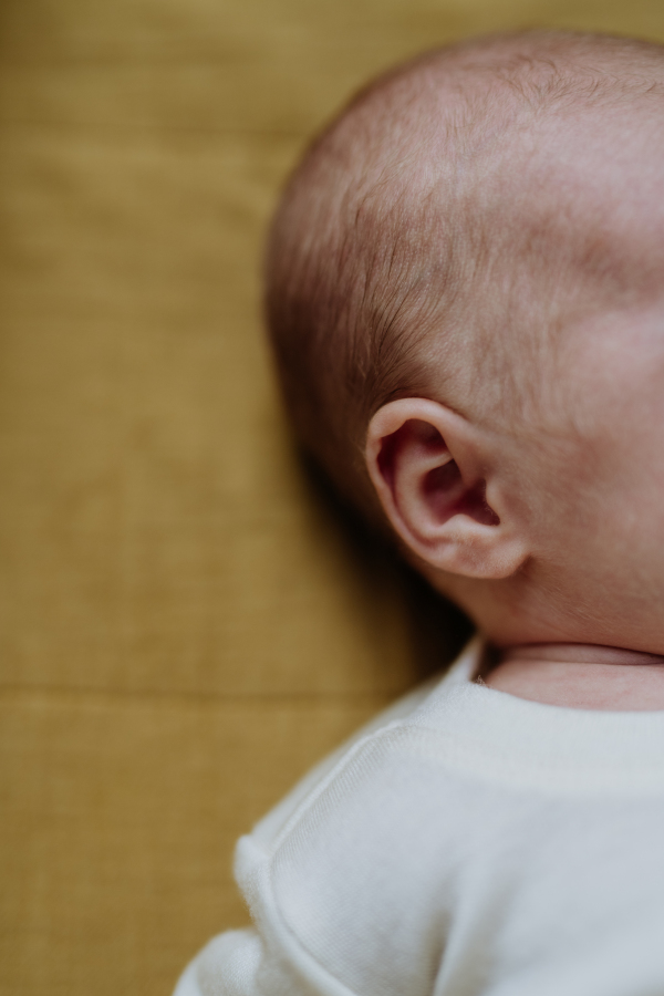 Close-up of babys head during the sleep in a bed.