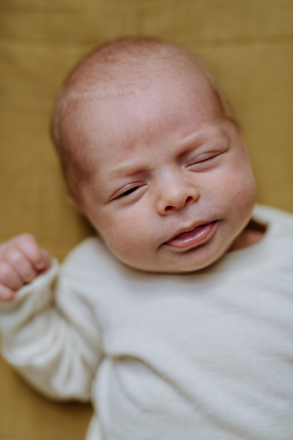 High angle view of newborn baby in little bed.