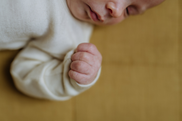 Close-up of babys head during the sleep in a bed.