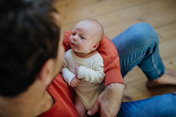 Close-up of father holding his little new born baby.