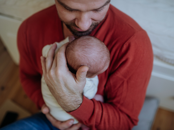 Close-up of father holding his little new born baby.