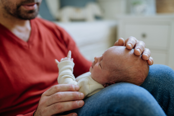 Close-up of father holding his little new born baby.