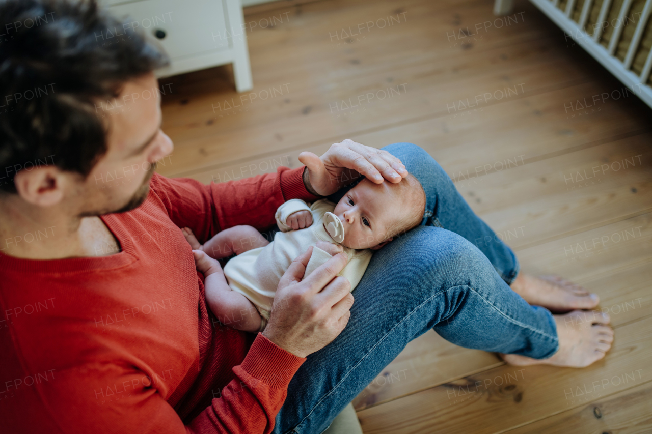 Close-up of father holding his little new born baby.