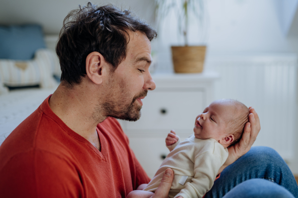 Close-up of father holding his little new born baby.