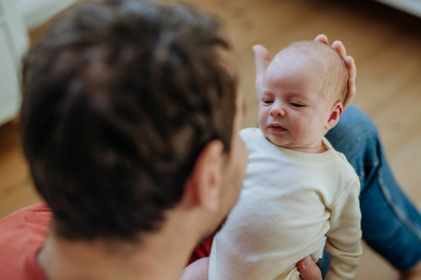 Close-up of father holding his little new born baby.