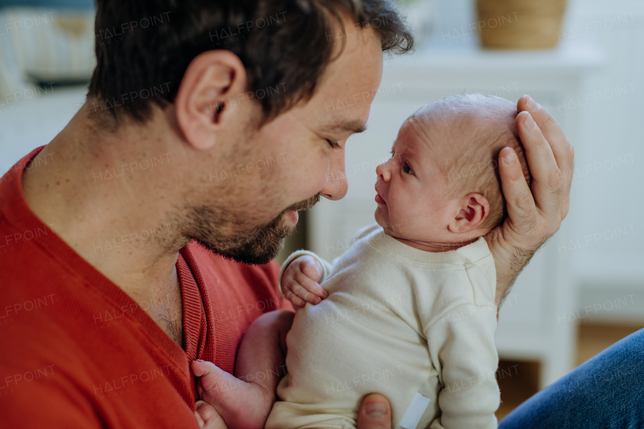 Close-up of father holding his little new born baby.