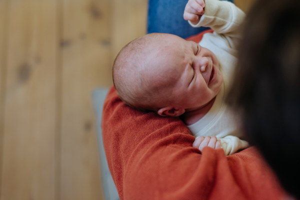 Close-up of father cuddling his little new born baby.