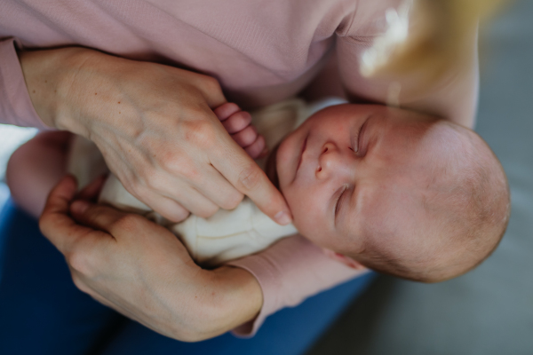 Mother cuddling her newborn baby in the bad.