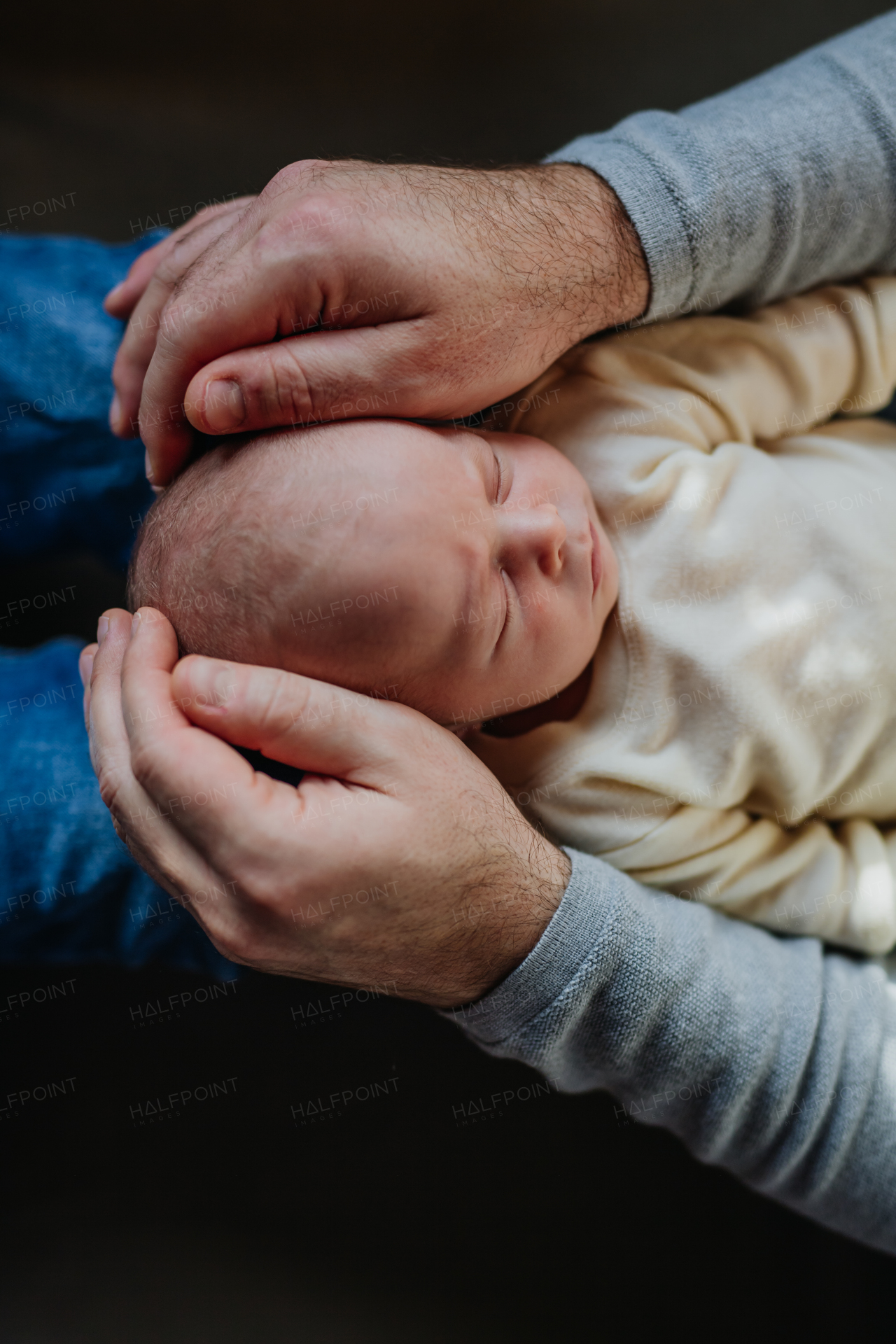 Close-up of father cuddling his little new born baby.